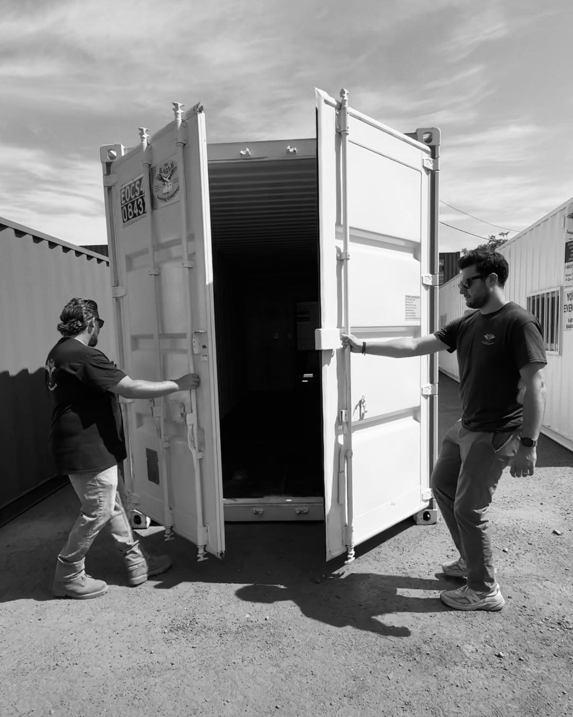 two-men-opening-shipping-container-doors