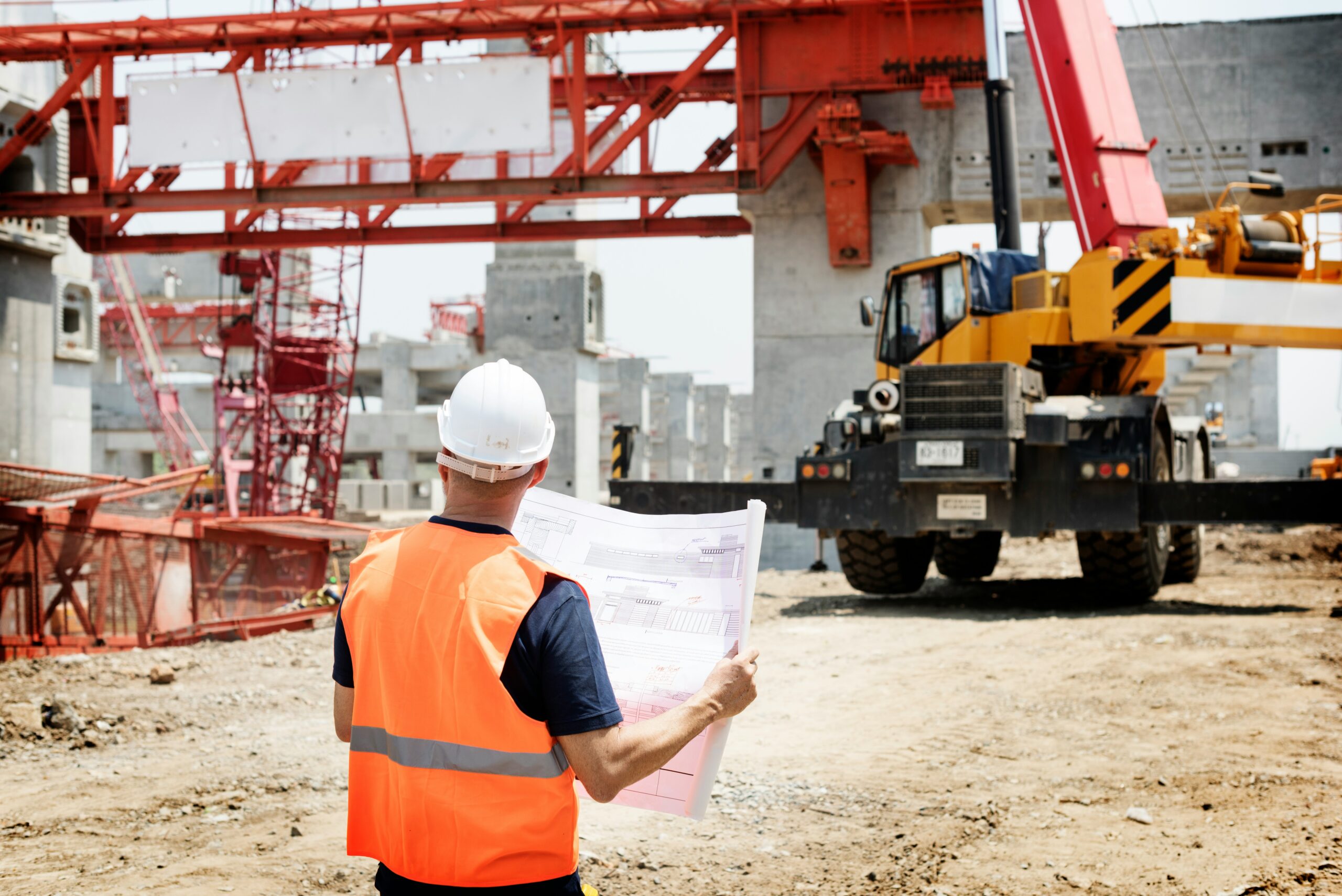 Man standing looking out at construction site